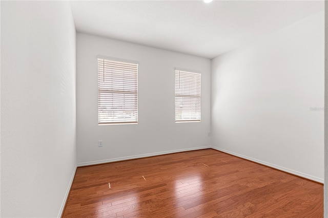 spare room with wood-type flooring