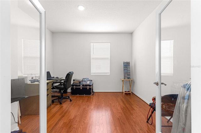 office area featuring a textured ceiling and hardwood / wood-style flooring