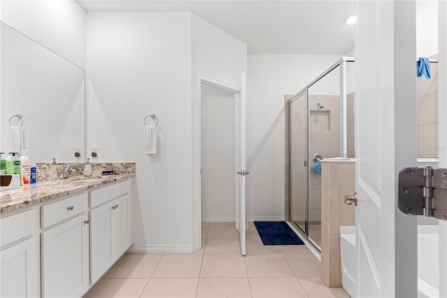 bathroom with vanity, tile patterned flooring, and a shower with door