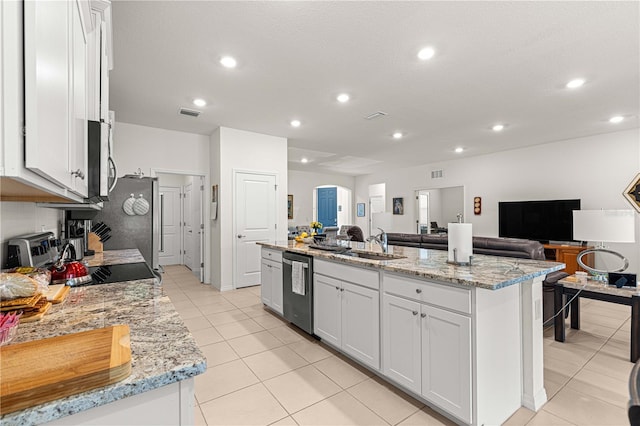 kitchen with white cabinets, a kitchen island with sink, sink, and stainless steel appliances