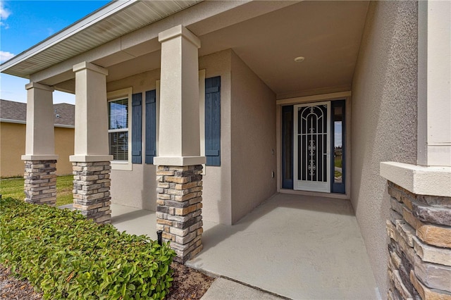 view of exterior entry featuring a porch