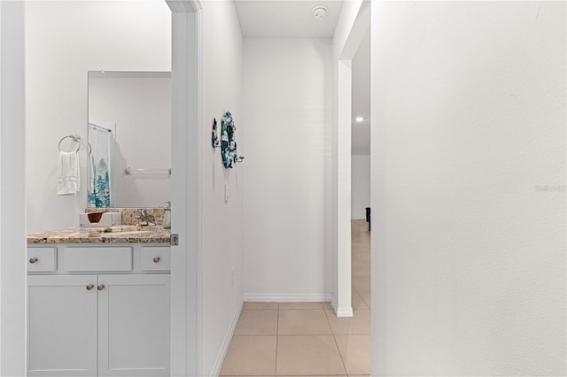 interior space with light tile patterned floors and sink