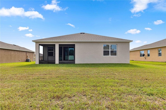 back of property featuring a lawn, central AC, and a sunroom