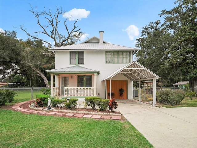 712 SW 10th Ave, Ocala, FL 34471 - view of front facade with covered porch, metal roof, driveway, stucco siding, and a carport