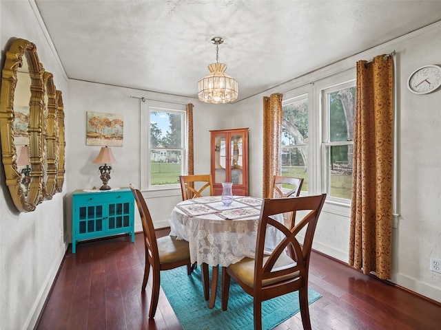 712 SW 10th Ave, Ocala, FL 34471 - dining room with wood-type flooring, baseboards, a chandelier, and crown molding