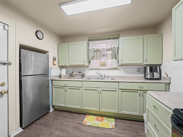 712 SW 10th Ave, Ocala, FL 34471 - kitchen with green cabinetry, freestanding refrigerator, a sink, and light countertops