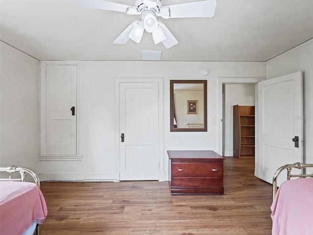 bedroom with light hardwood / wood-style floors and ceiling fan