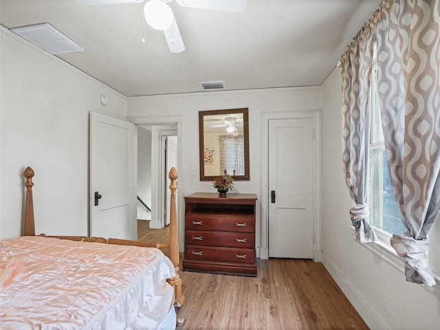 bedroom with ceiling fan and light hardwood / wood-style floors