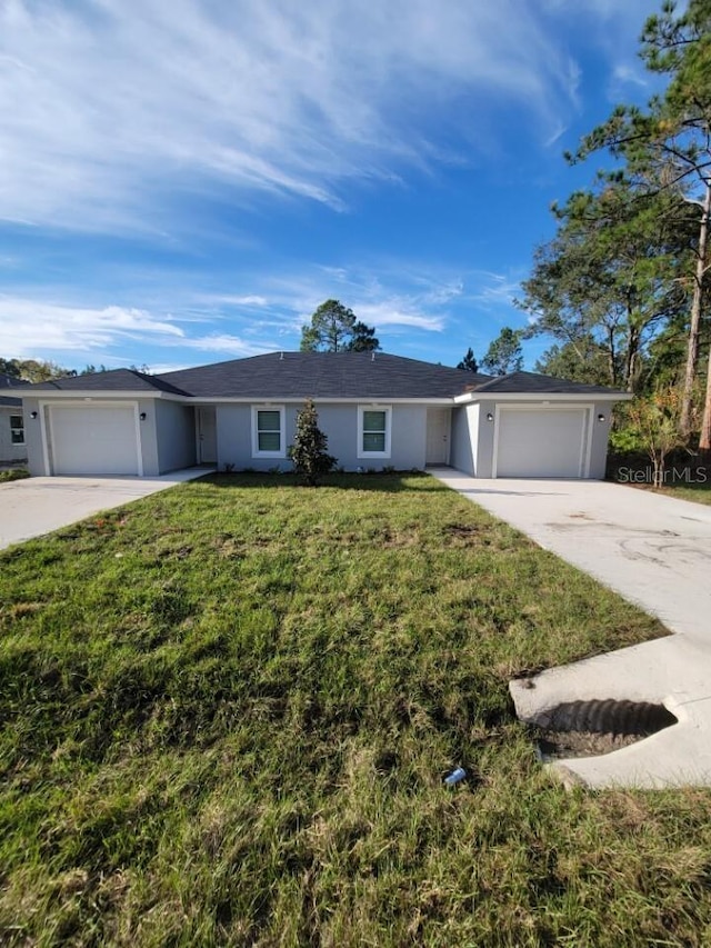 single story home featuring a front yard and a garage