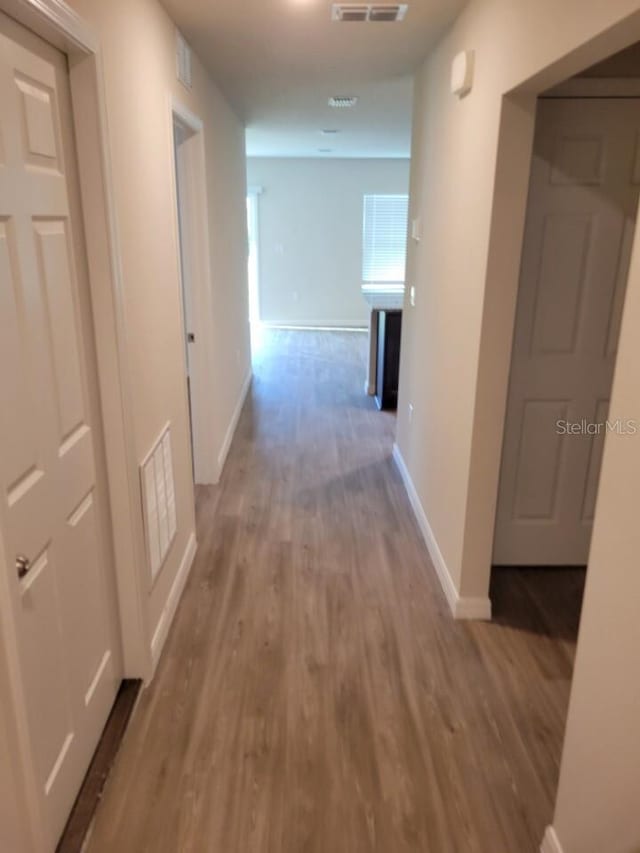 corridor with light hardwood / wood-style floors