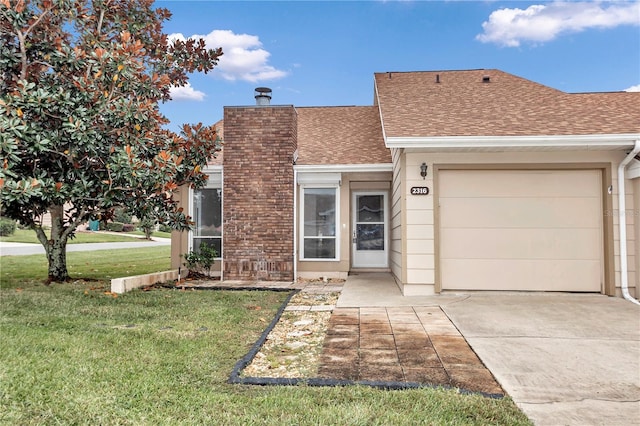 view of front facade featuring a front yard and a garage