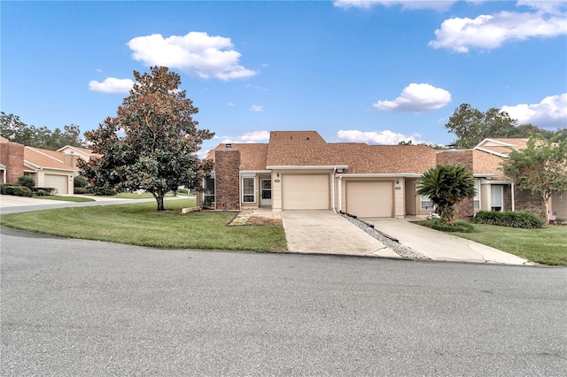 view of front of property featuring a front yard and a garage