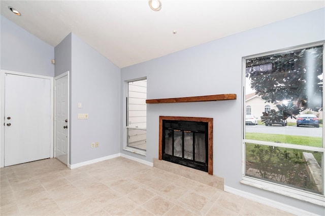 unfurnished living room with light tile patterned floors, a fireplace, and vaulted ceiling