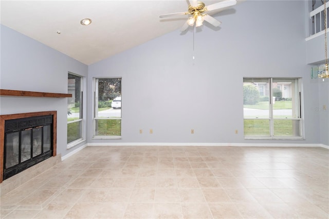 unfurnished living room with ceiling fan, high vaulted ceiling, light tile patterned flooring, and a fireplace