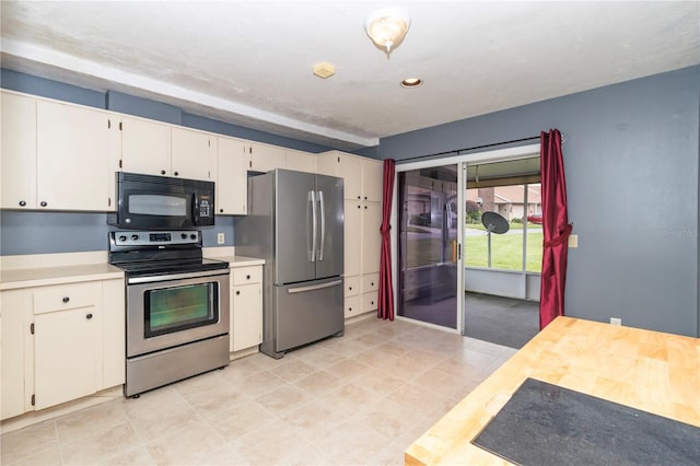 kitchen with white cabinetry and stainless steel appliances