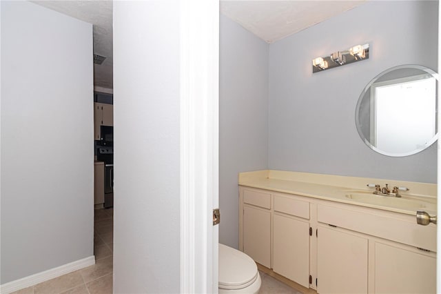 bathroom featuring vanity, a textured ceiling, toilet, and tile patterned flooring