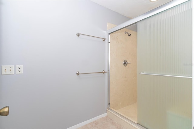 bathroom featuring tile patterned floors and a shower with shower door