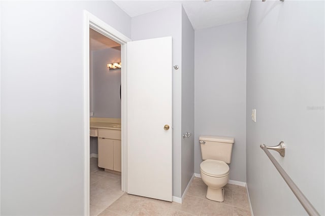 bathroom with toilet and tile patterned flooring