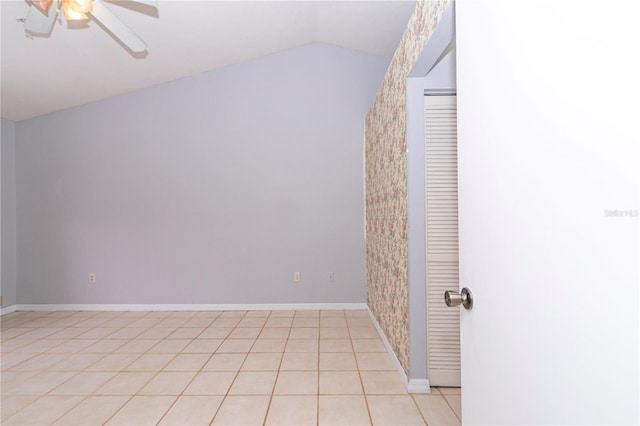 interior space featuring ceiling fan, vaulted ceiling, and light tile patterned floors