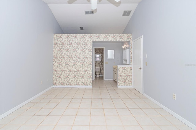 tiled empty room with ceiling fan and lofted ceiling