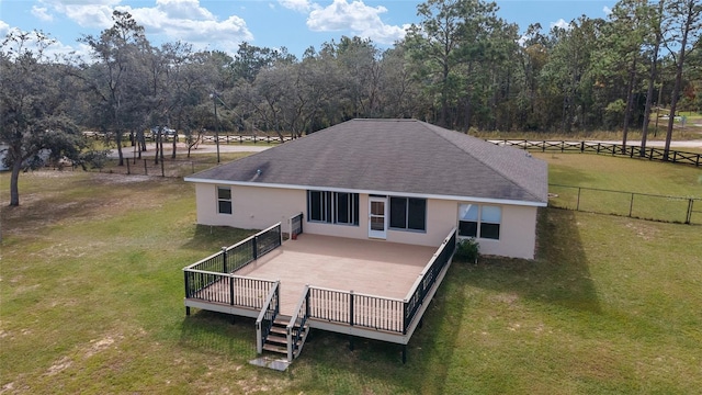 back of house with a deck and a lawn