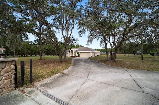 ranch-style house with a front yard and a garage