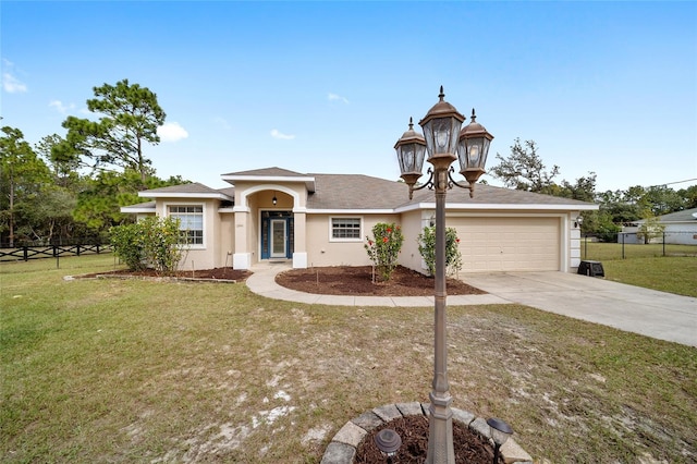 view of front of home with a front yard and a garage