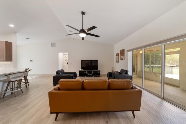 living room featuring lofted ceiling, light hardwood / wood-style flooring, and ceiling fan