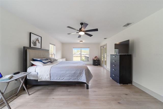 bedroom with ceiling fan and light wood-type flooring