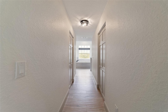 hall with light hardwood / wood-style flooring