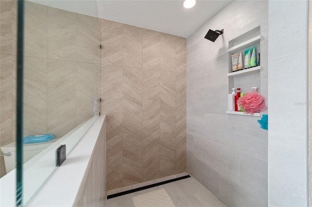 bathroom featuring tile walls and a shower