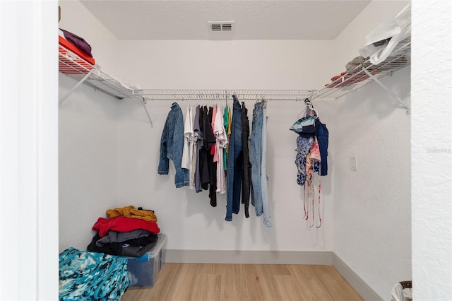 walk in closet featuring hardwood / wood-style flooring