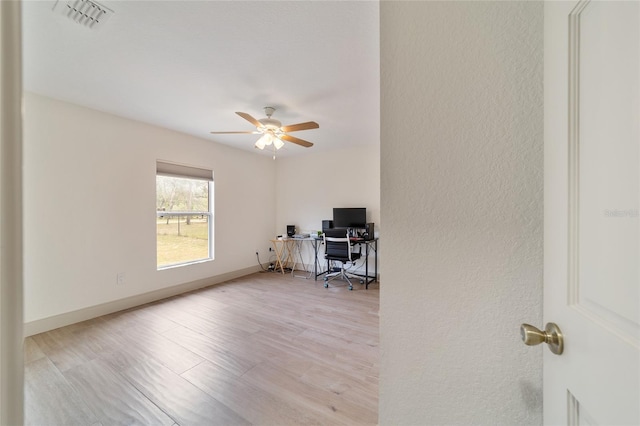 office space with light wood-type flooring and ceiling fan