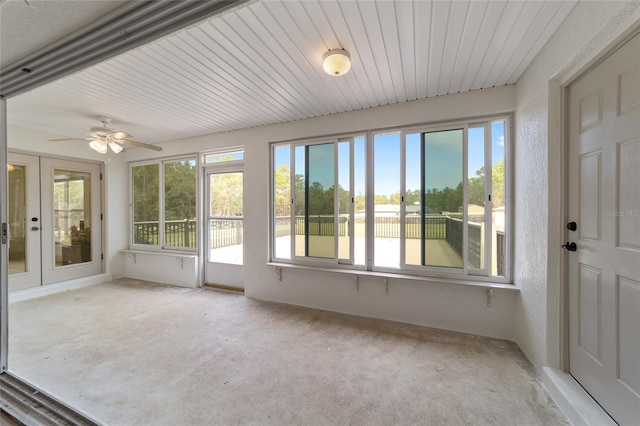 unfurnished sunroom featuring french doors and ceiling fan