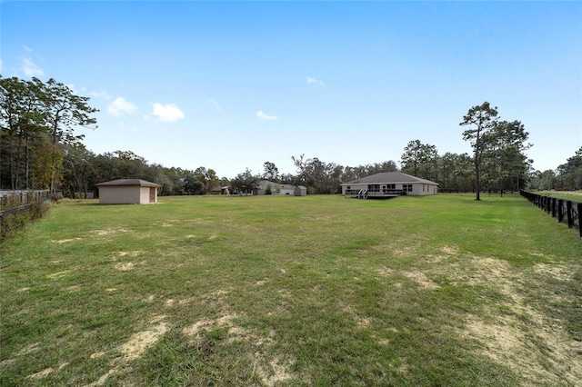 view of yard with a rural view and an outbuilding