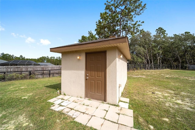 view of outdoor structure featuring a lawn