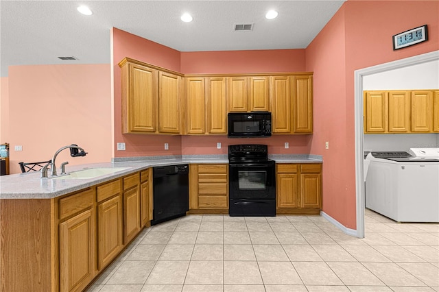 kitchen featuring black appliances, sink, separate washer and dryer, kitchen peninsula, and light tile patterned floors