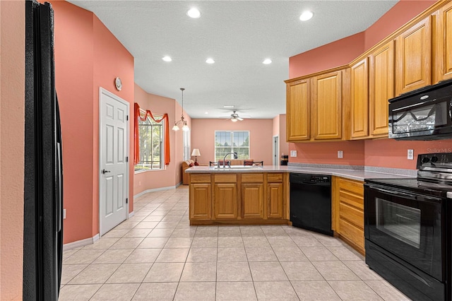 kitchen featuring black appliances, sink, kitchen peninsula, ceiling fan, and light tile patterned floors