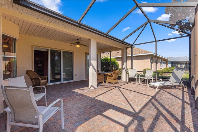 view of patio / terrace featuring ceiling fan and a lanai