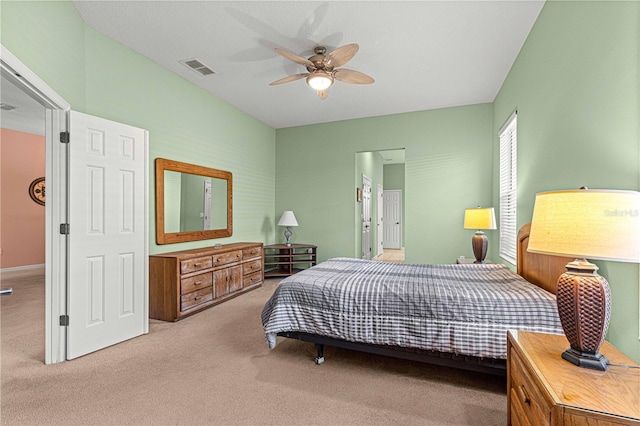 bedroom with light carpet and ceiling fan