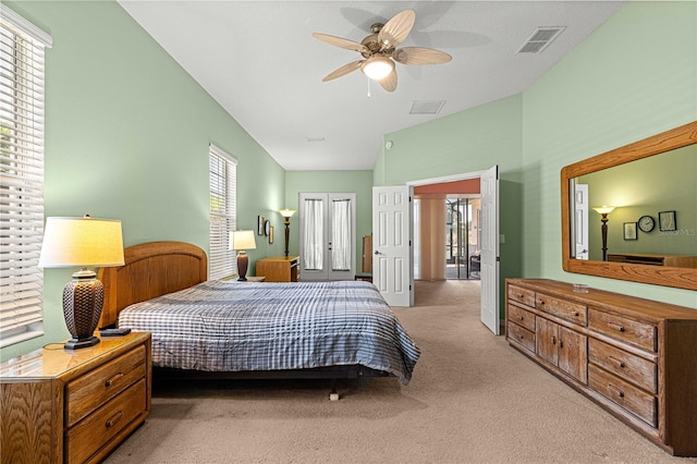 bedroom with lofted ceiling, light colored carpet, and ceiling fan