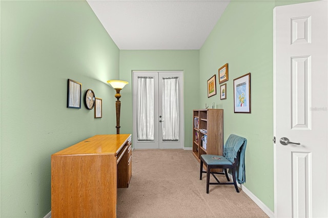 living area with french doors and light colored carpet