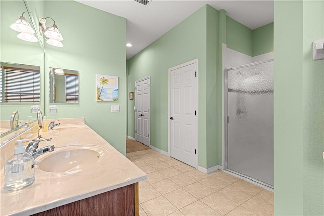 bathroom featuring vanity, walk in shower, and tile patterned flooring