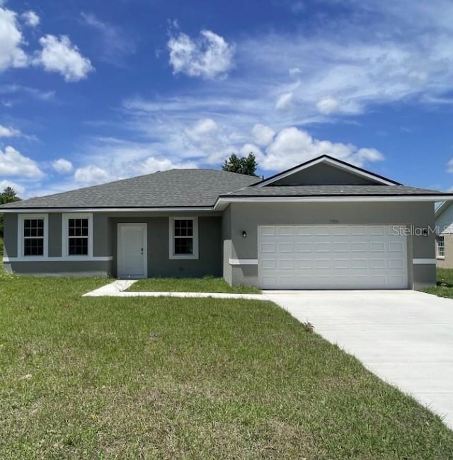 single story home featuring a front lawn and a garage