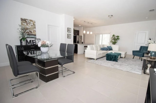 dining space with an inviting chandelier and light tile patterned floors