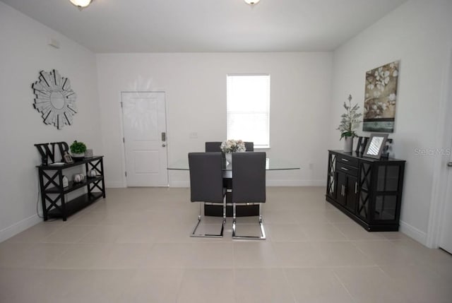 dining space featuring light tile patterned floors