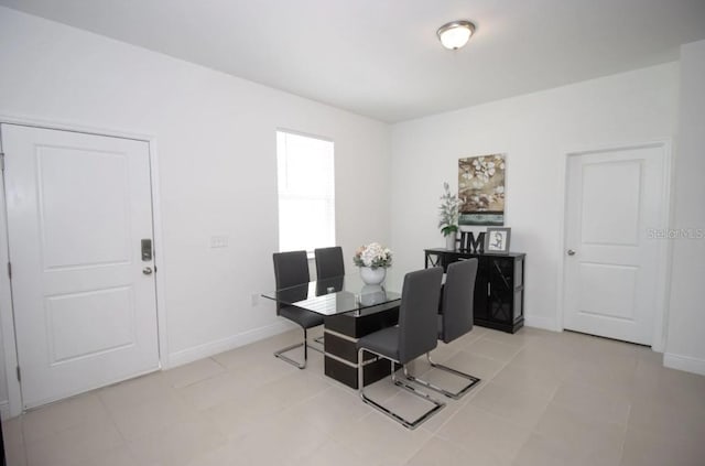 dining space featuring light tile patterned floors