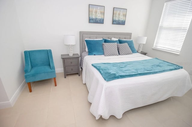 bedroom with light tile patterned floors