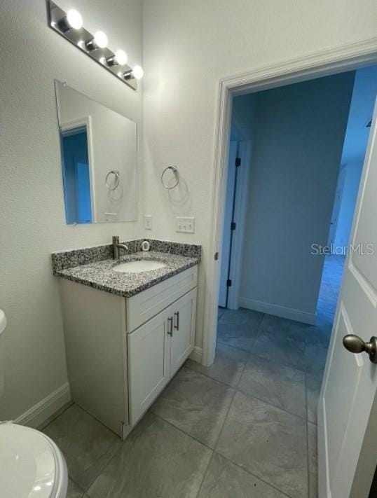 bathroom featuring vanity and toilet