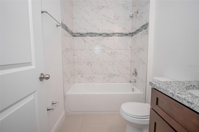 full bathroom with toilet, tiled shower / bath, vanity, and tile patterned floors